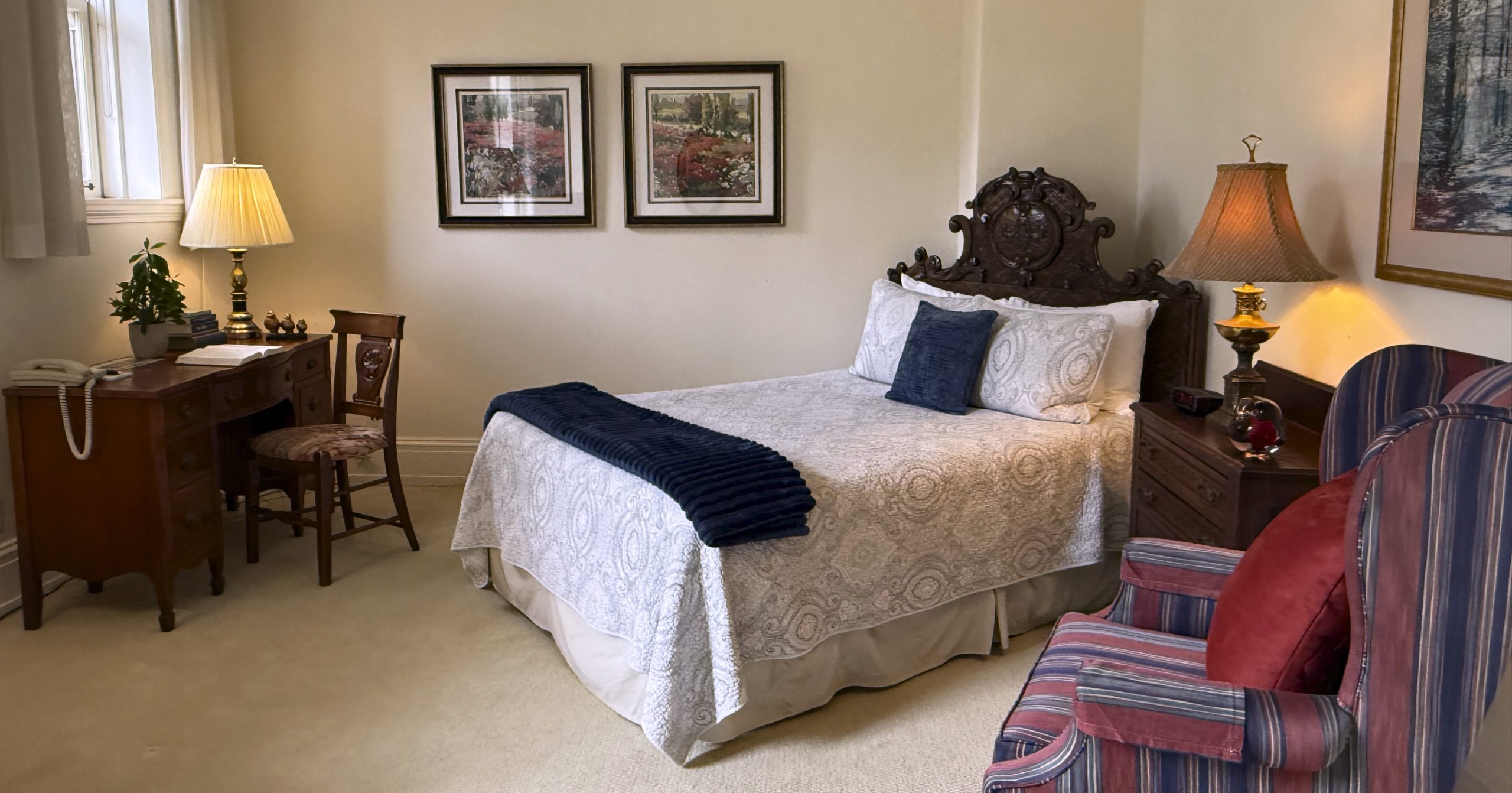 Small Studio-1 Small studio Arden Wood residential room with a queen bed, desk and red armchair