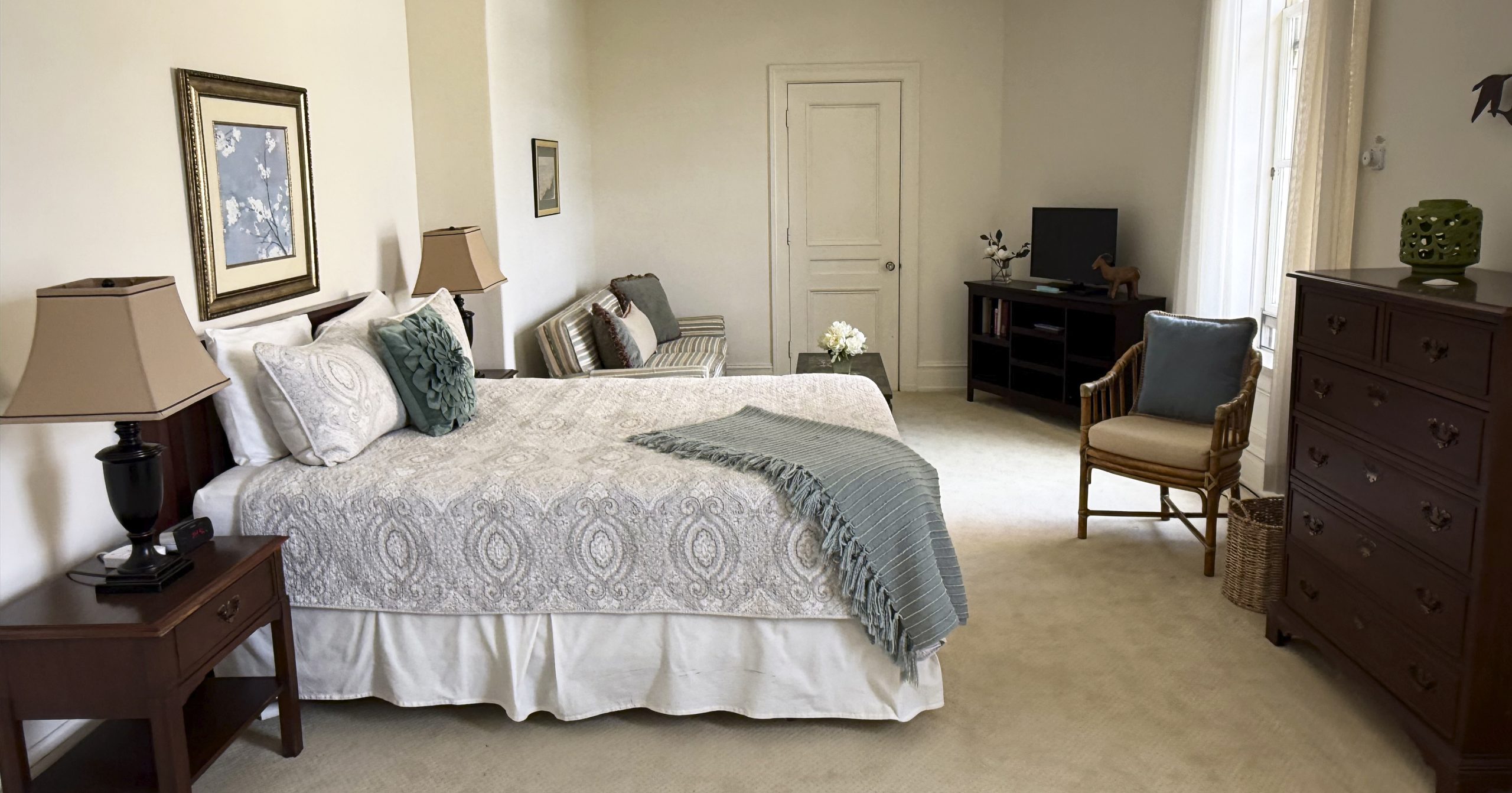 AW large studio Large studio Arden Wood residential room with a queen bed and loveseat couch